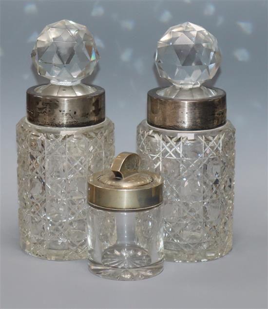 A pair of late Victorian silver mounted cut glass large jars by Saunders & Shepherd, Chester 1895 & a salts bottle.